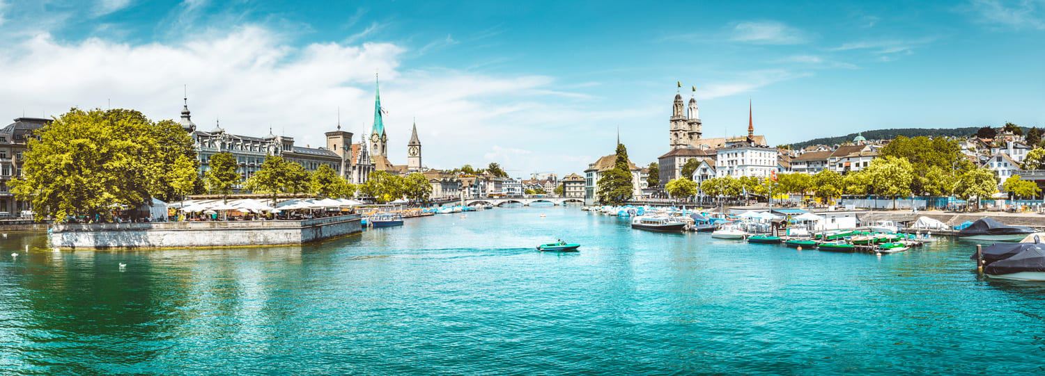 Image of the Limmat in Zurich with Bauschänzli, cathedral and other sights.