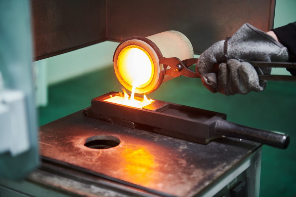 Picture showing how a gold bar is cast in a gold refinery.
